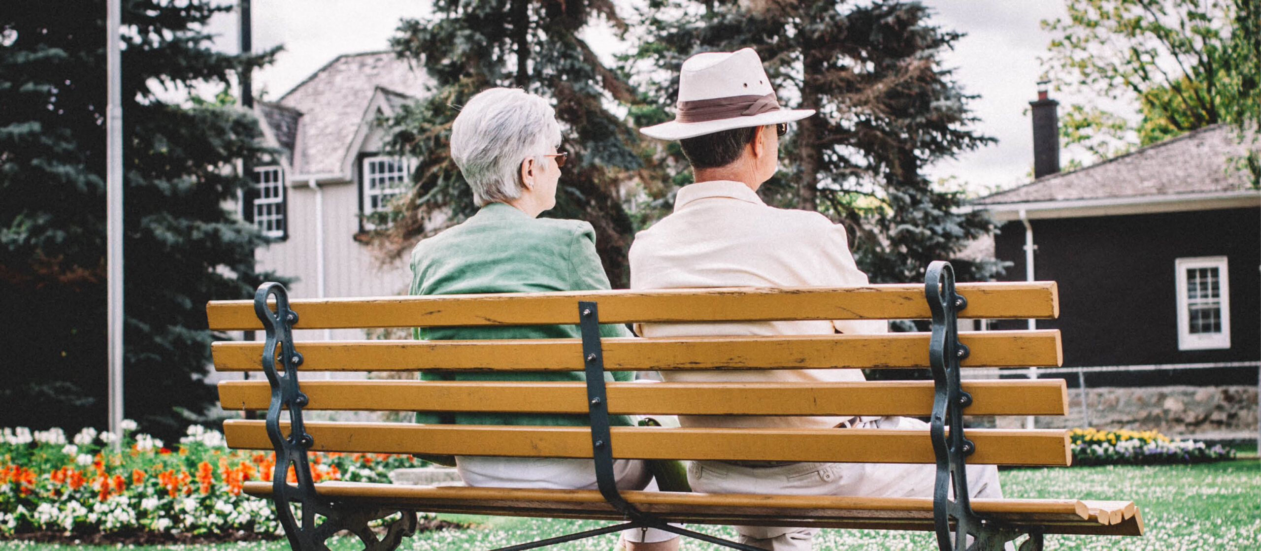 Two senior citizens sitting on a park bench